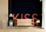 Vibrant Neon Kiss Lettering on Dark Brick Wall Mural 8