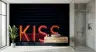 Vibrant Neon Kiss Lettering on Dark Brick Wall Mural 6